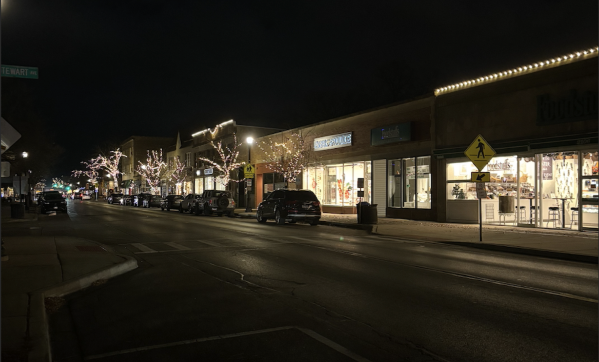 Holiday lighting adds to the festive atmosphere of the storefronts.